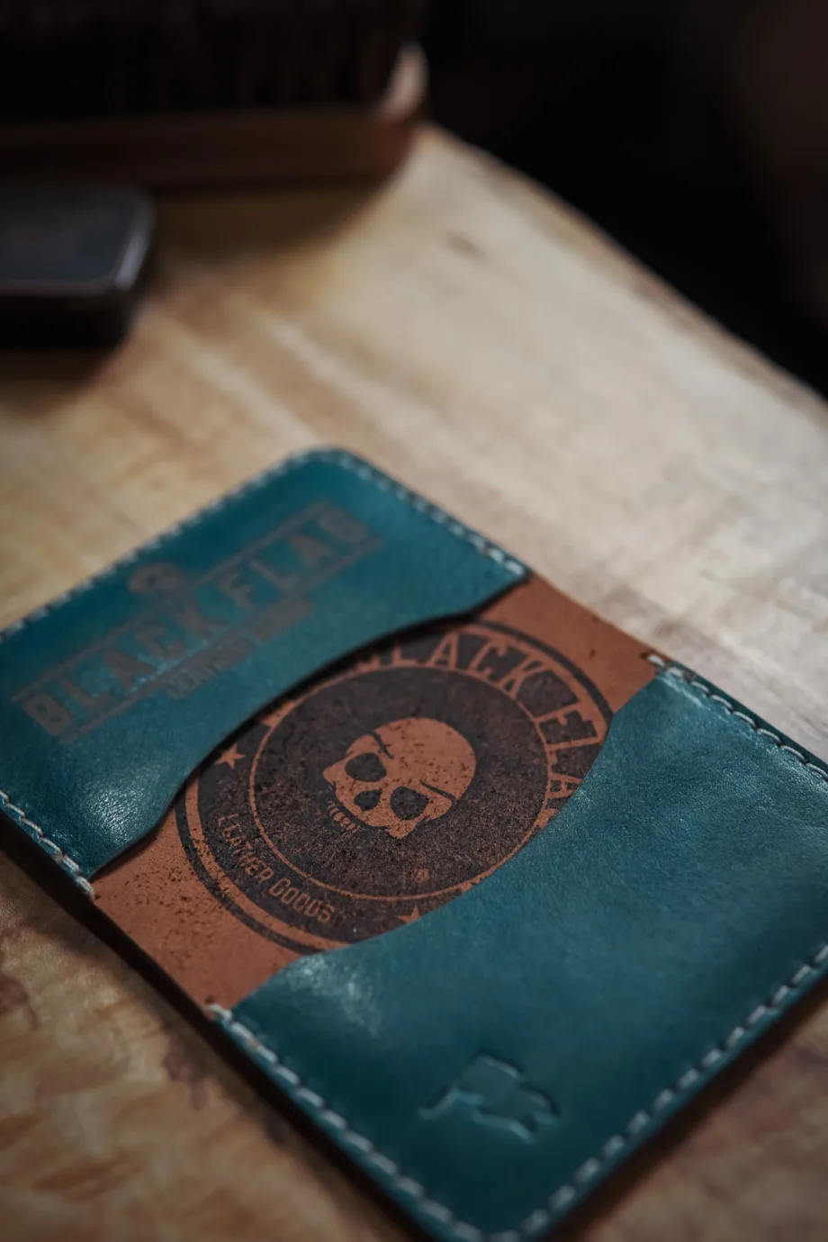 Close up of stamp on leather minimalist bifold cardholder