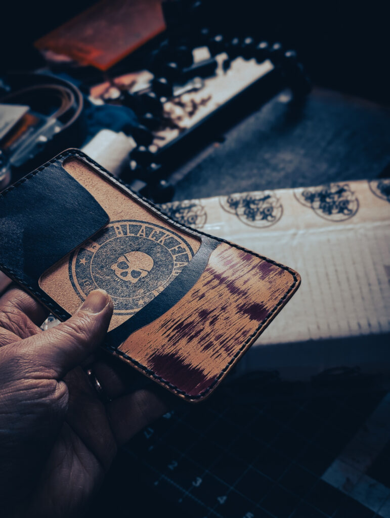 The front side of a leather money flap card holder made out of marbled leather.