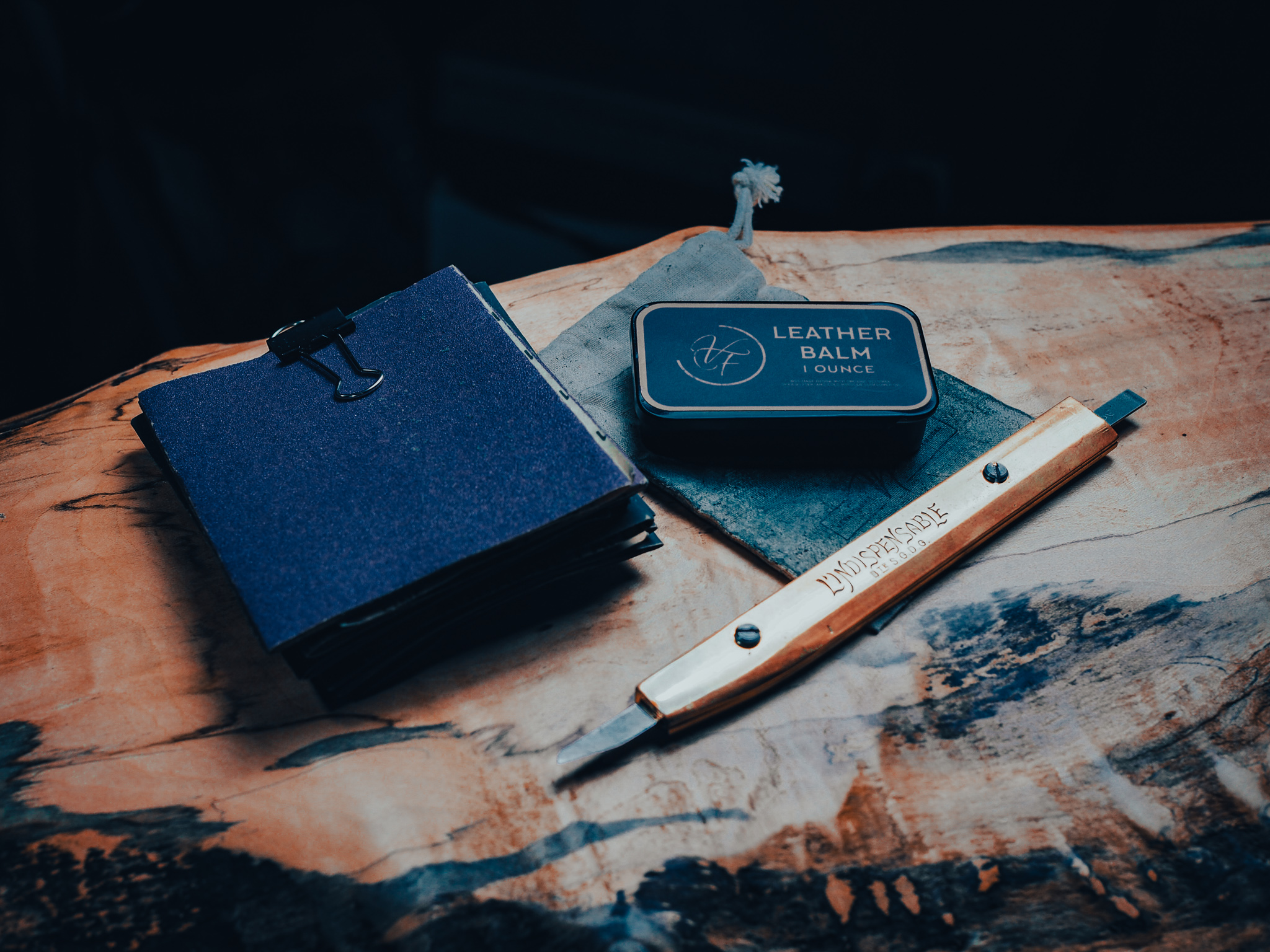 Sand paper, leather balm and a leather knife
