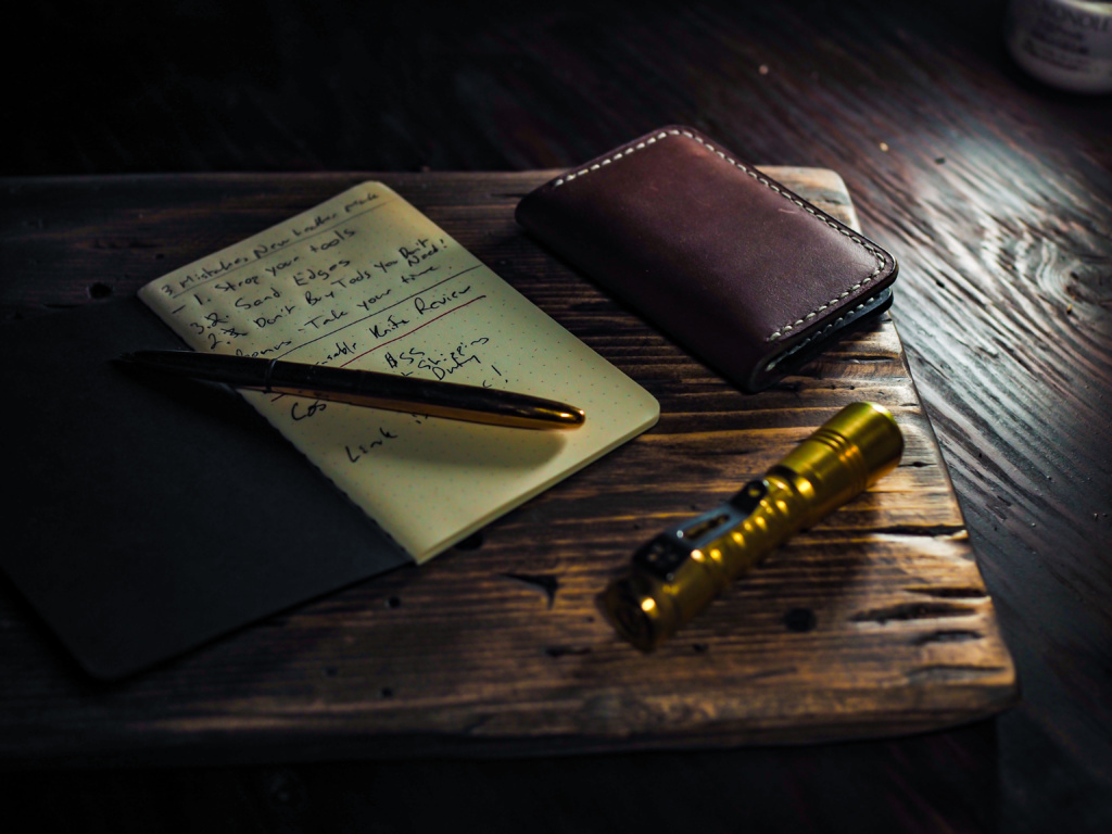 Leather wallet, Field Notes, and a Brass Fisher Spacepen